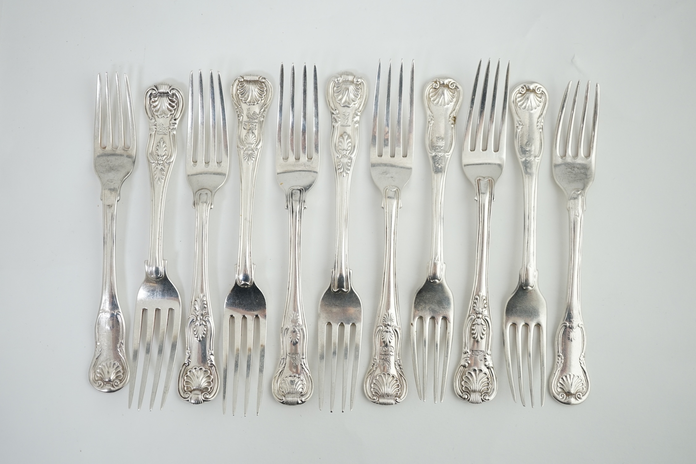 A harlequin set of eleven Georgian and Victorian silver Kings pattern dessert forks, various dates and makers